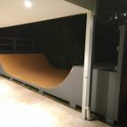 3.5ft high mini ramp (half-pipe skateboard) ramp, painted grey and orange off verandah at twilight