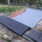 2.5ft high mini ramp (half pipe skateboard ramp) painted black & grey, custom landscaping