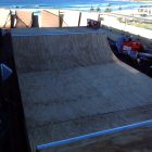 1.5ft mini ramp (half pipe skateboard ramp) on balcony with beach view in background