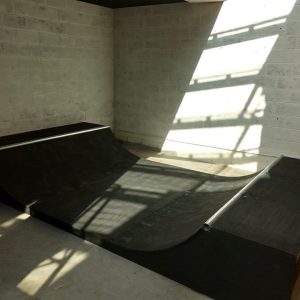1.5ft mini ramp (half pipe skateboard ramp) in a room