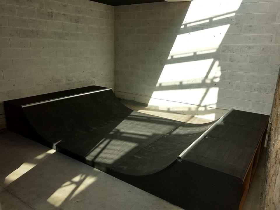1.5ft mini ramp (half pipe skateboard ramp) in a room