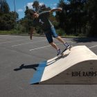 60cm rolled flat bank (hump) skateboard ramp with skater doing kick turn in a car park