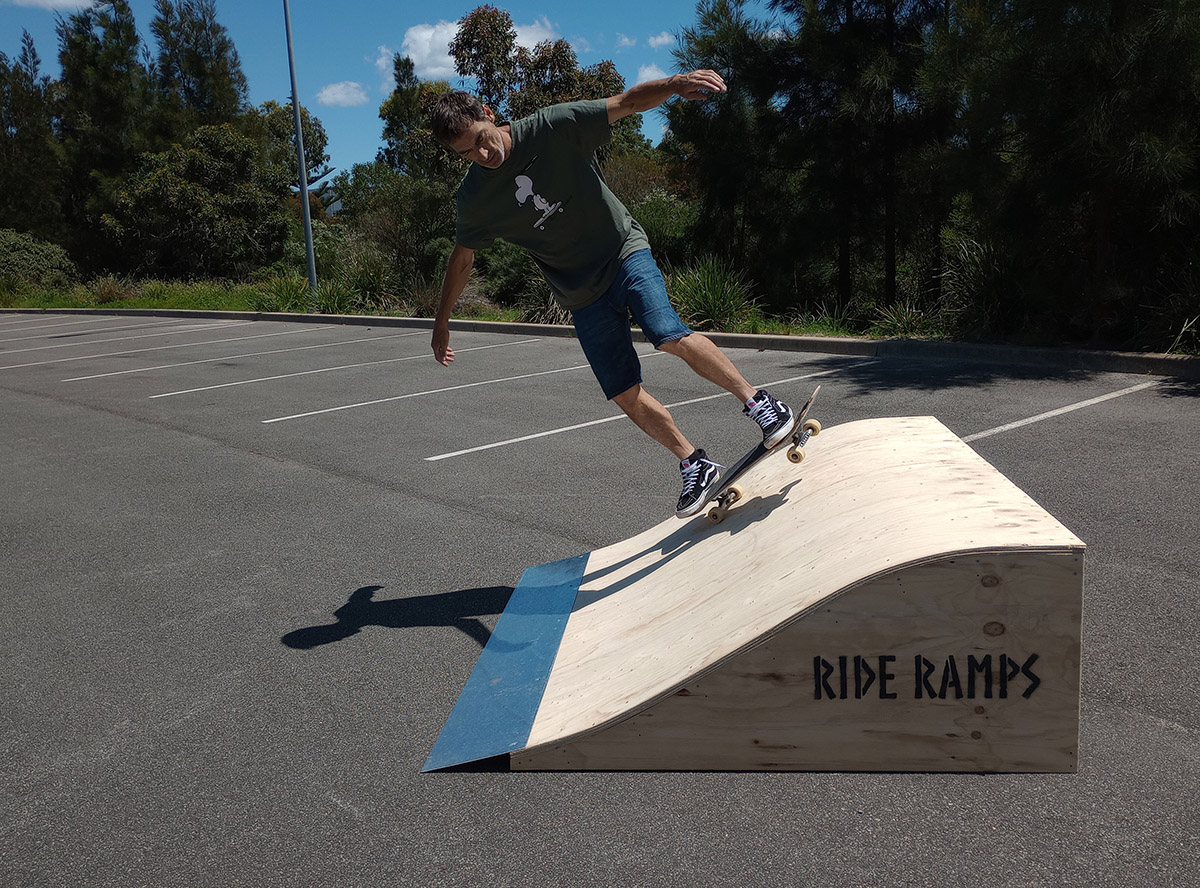 60cm rolled flat bank (hump) skateboard ramp with skater doing kick turn in a car park