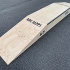 25cm high double launch ramp (wedge skateboard ramp) - grind pad (manual pad-grind box) combo in raw timber, diagonal view.