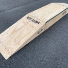 30cm high double launch ramp (wedge skateboard ramp) - grind pad (manual pad-grind box) combo in raw timber, diagonal view.