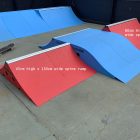 45cm high and 60cm high spine ramps in red, in a pop up skate park.